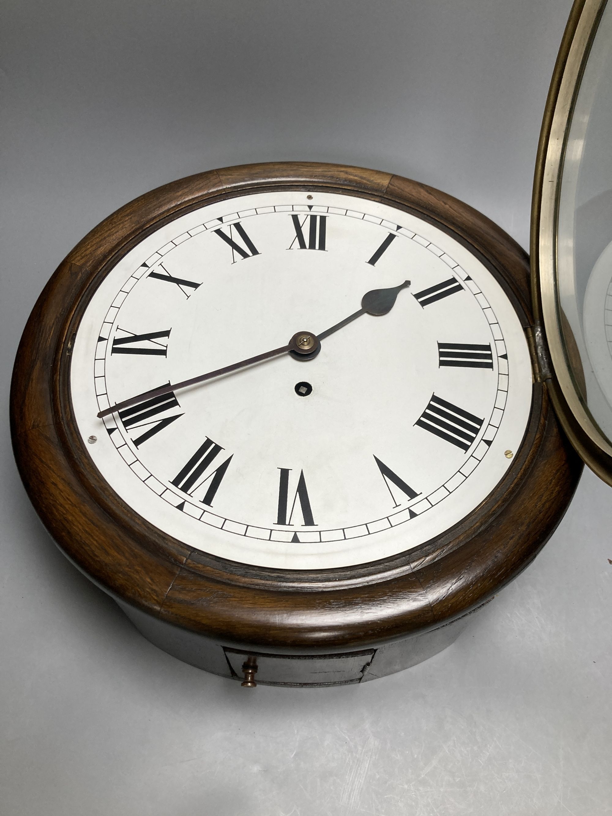 An oak cased single fusee dial wall clock, black Roman numerals on a white 12